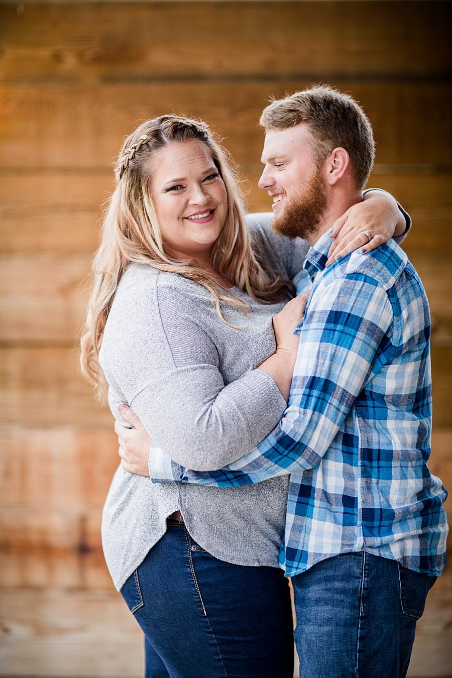 Arms around waist at this The Stables at Strawberry Creek Engagement Session by Knoxville Wedding Photographer, Amanda May Photos.