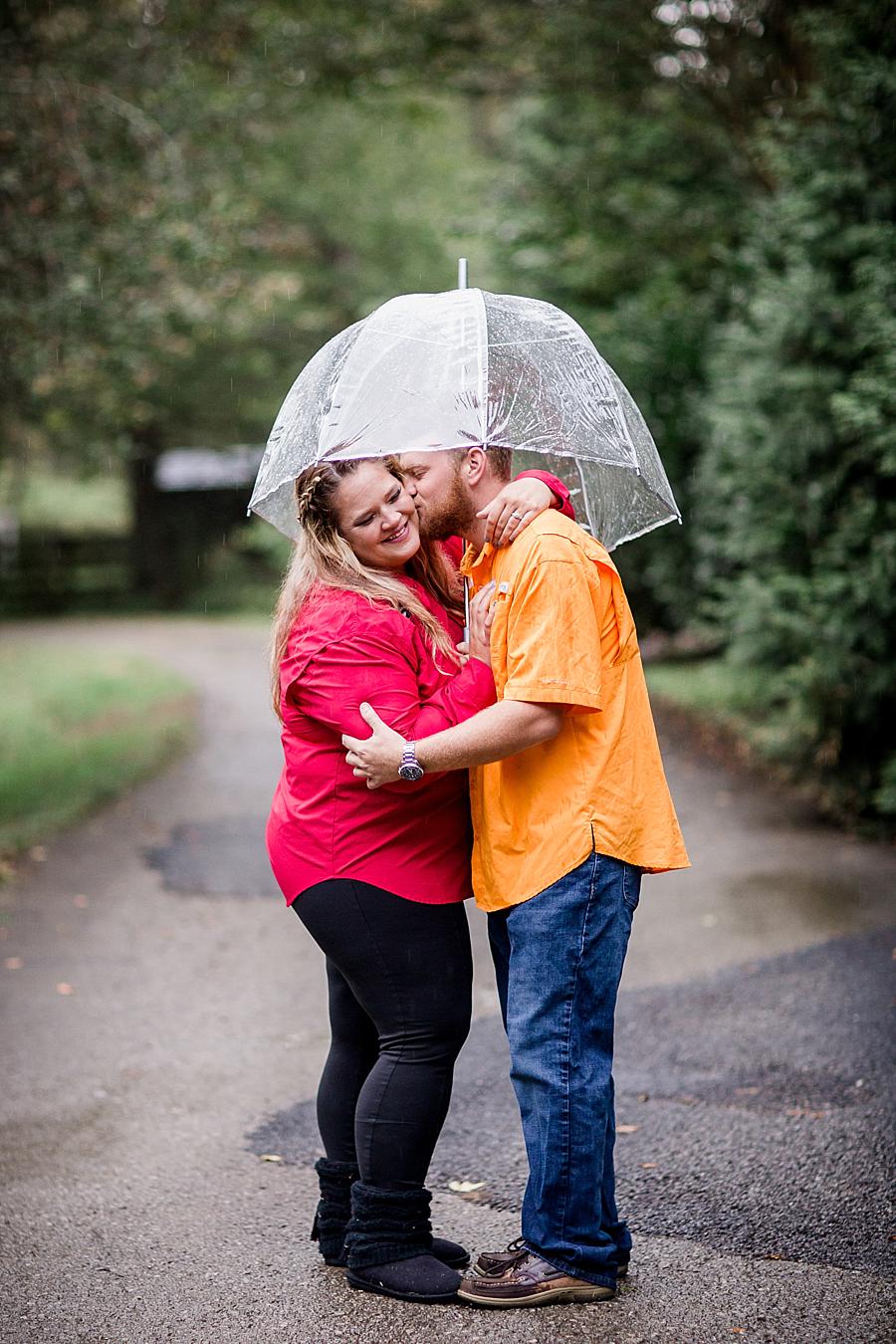 Clear umbrella at this The Stables at Strawberry Creek Engagement Session by Knoxville Wedding Photographer, Amanda May Photos.
