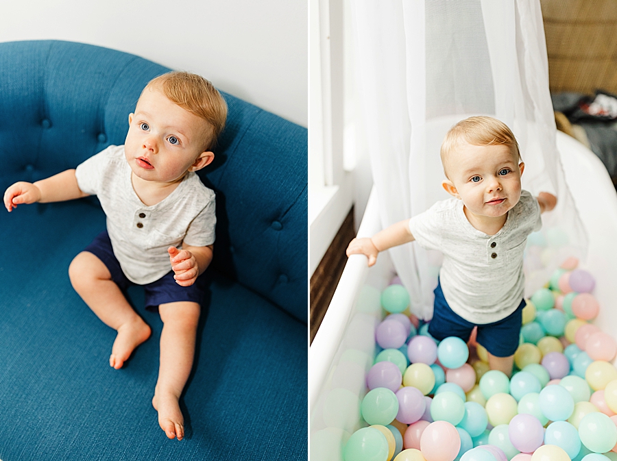 baby sitting in a ball pit