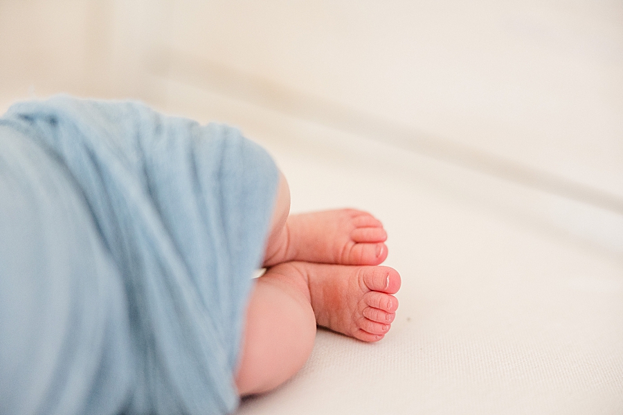 baby feet sticking out of blue swaddle