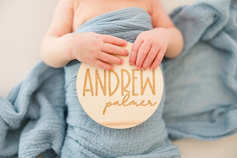 newborn holding personalized nametag