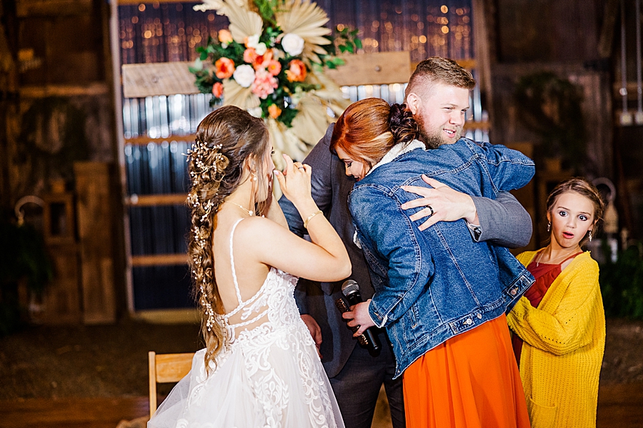 bridesmaid hugging groom