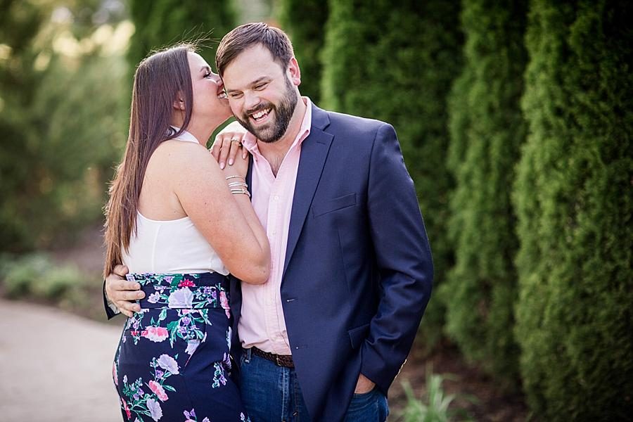 Whispering in his ear at this Knoxville Botanical Engagement session by Knoxville Wedding Photographer, Amanda May Photos.