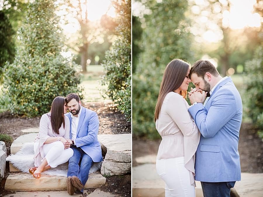 Kissing her hands at this Knoxville Botanical Engagement session by Knoxville Wedding Photographer, Amanda May Photos.
