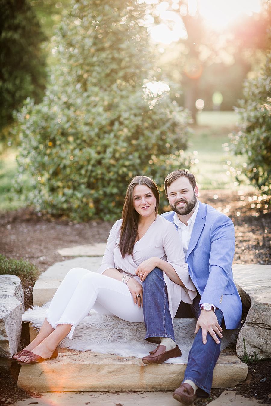 Sitting looking at camera at this Knoxville Botanical Engagement session by Knoxville Wedding Photographer, Amanda May Photos.