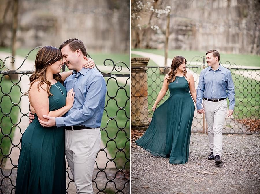 Walking in front of the fence at this Knoxville engagement session at The Quarry by Knoxville Wedding Photographer, Amanda May Photos.