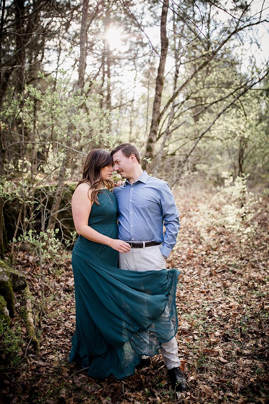 Dress blowing into him at this Knoxville engagement session at The Quarry by Knoxville Wedding Photographer, Amanda May Photos.