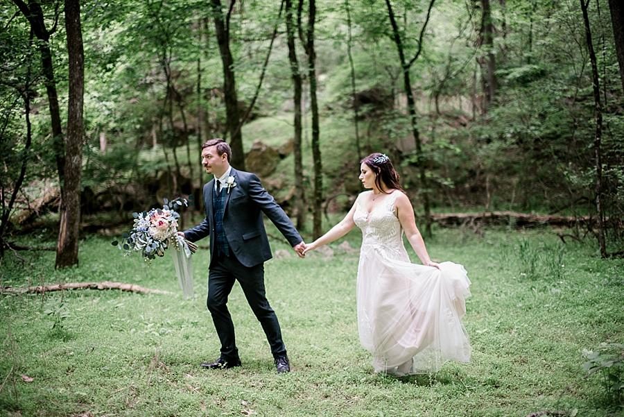 Walking through a field at this The Quarry wedding by Knoxville Wedding Photographer, Amanda May Photos.