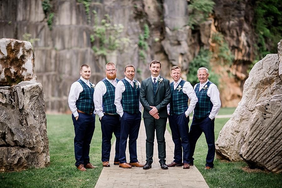 Groomsmen between two rocks at this The Quarry wedding by Knoxville Wedding Photographer, Amanda May Photos.
