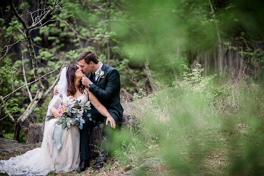 Kissing on the rocks at this The Quarry wedding by Knoxville Wedding Photographer, Amanda May Photos.