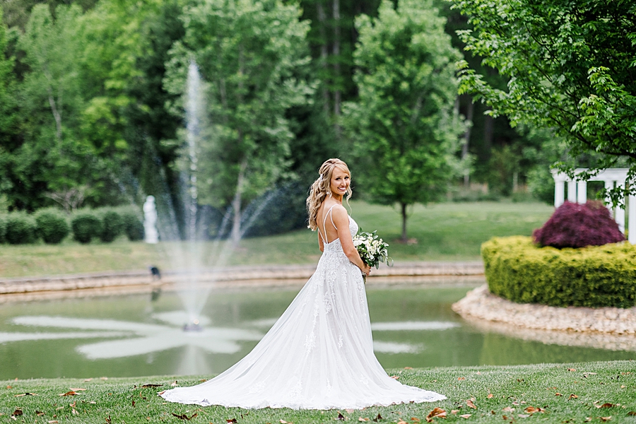 bride by large pond with fountain