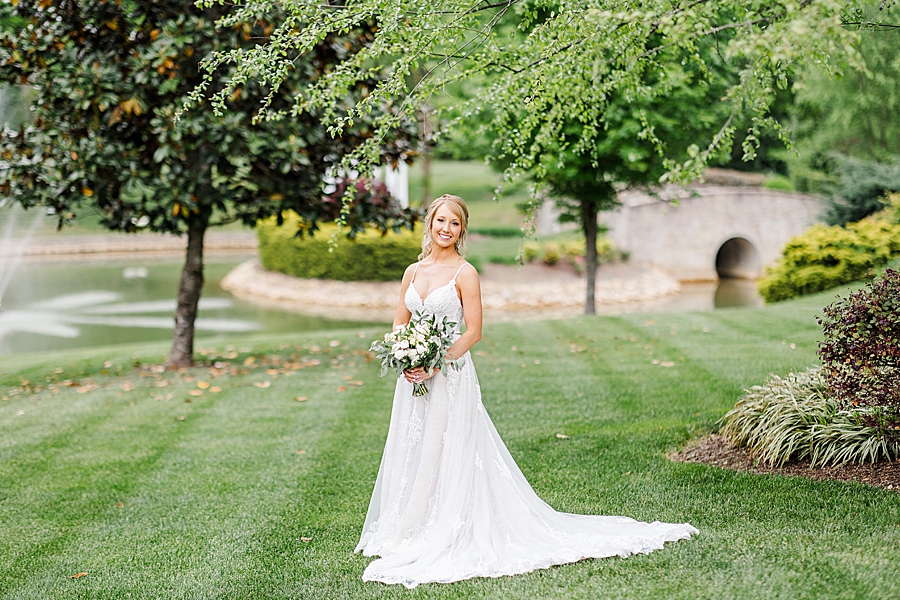 bride standing on manicured lawn