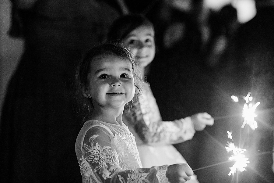 girls holding sparklers