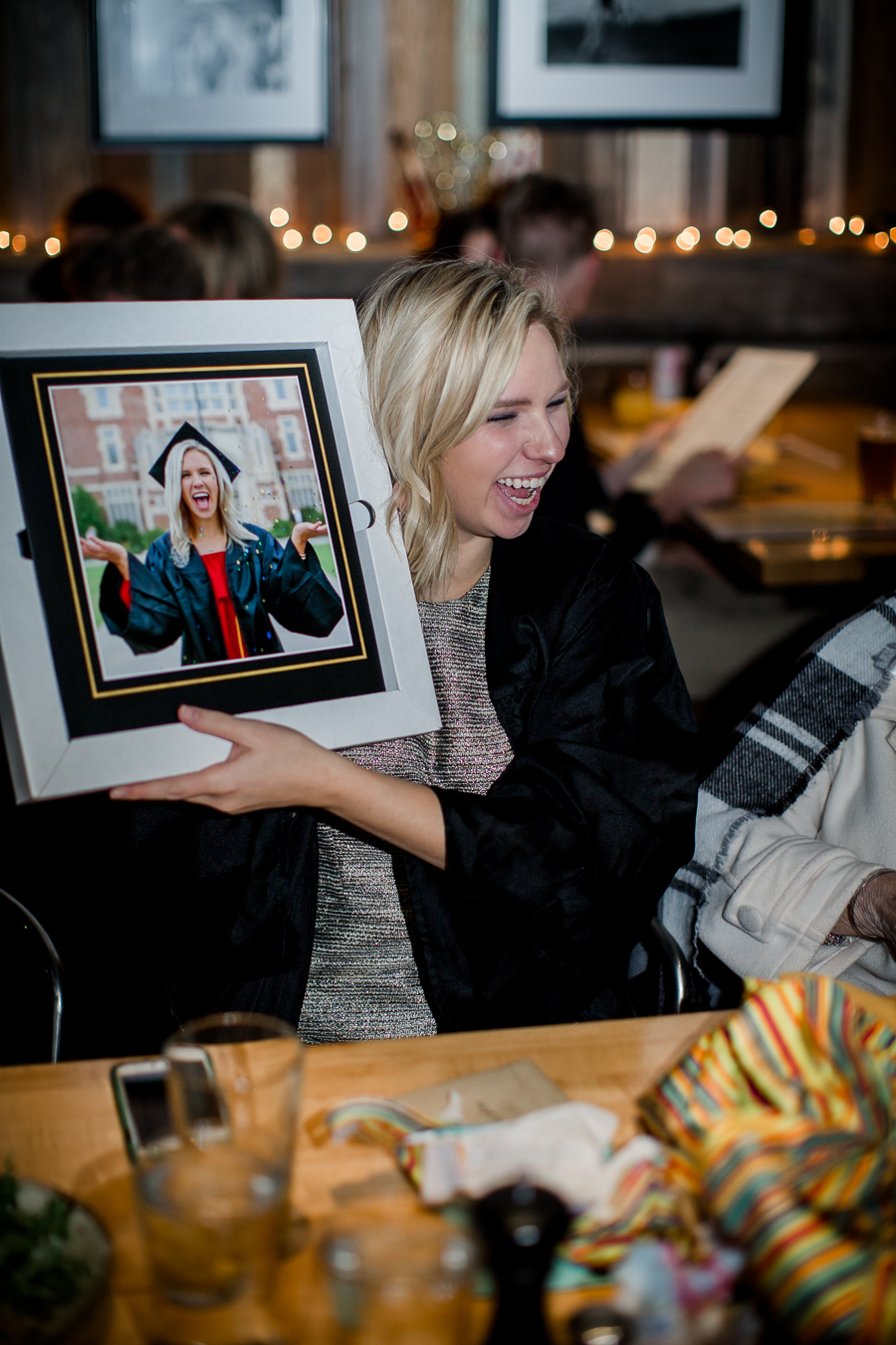 Holding up her book at this dinner at Sunspot after the University of Tennessee graduation by Amanda May Photos.