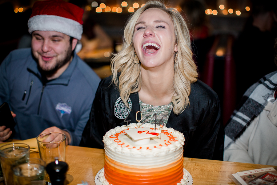 Laughing behind her cake at this dinner at Sunspot after the University of Tennessee graduation by Amanda May Photos.
