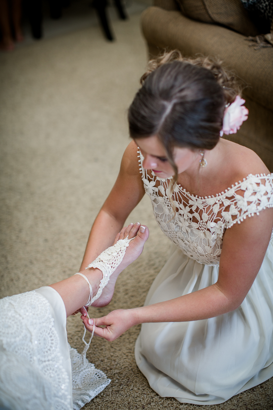 Getting help putting on sand shoes at this Daytona Beach Wedding by Destination Wedding Photographer, Amanda May Photos.