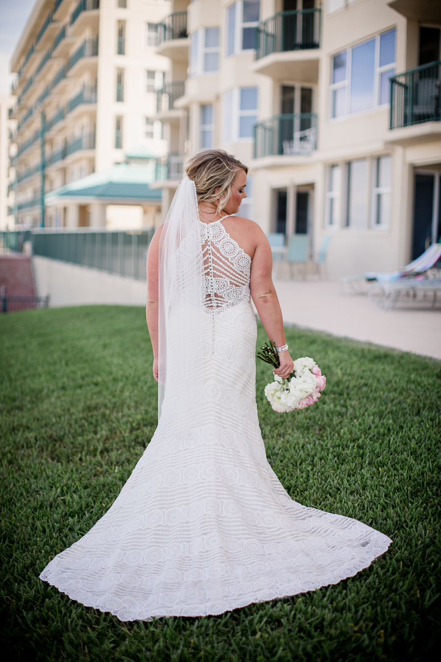Back of dress in front of hotel at this Daytona Beach Wedding by Destination Wedding Photographer, Amanda May Photos.