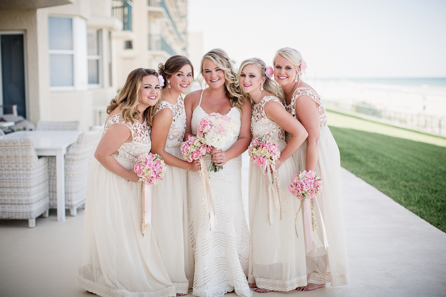 Bride with bridesmaids in front of hotel at this Daytona Beach Wedding by Destination Wedding Photographer, Amanda May Photos.