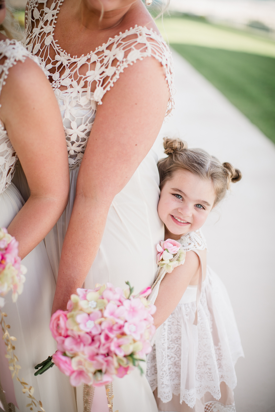 Flower girl hugging bride from behind at this Daytona Beach Wedding by Destination Wedding Photographer, Amanda May Photos.