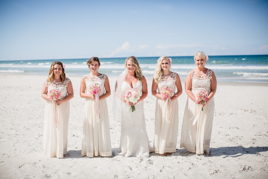 Bride with bridesmaids on beach at this Daytona Beach Wedding by Destination Wedding Photographer, Amanda May Photos.
