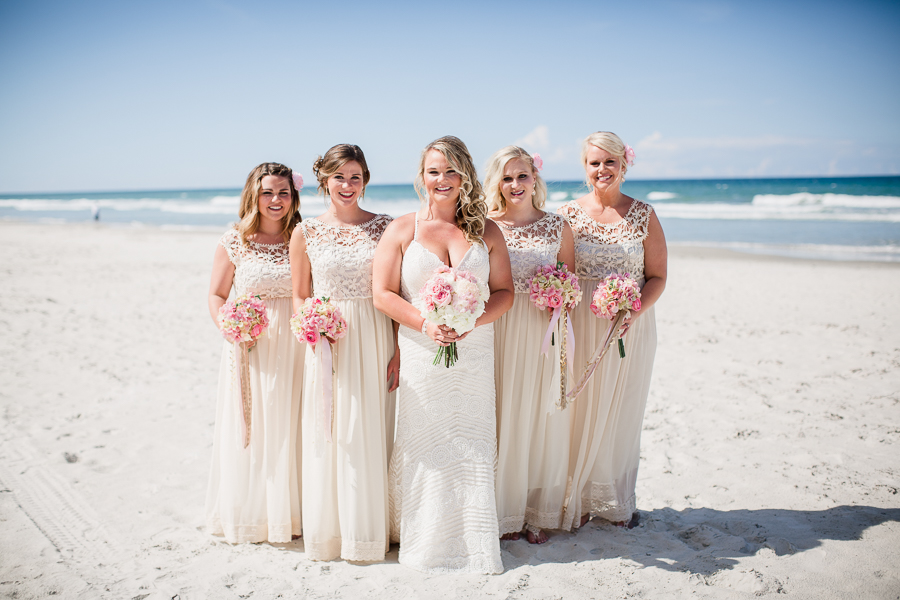 Bride with bridesmaids in V formation on the beach at this Daytona Beach Wedding by Destination Wedding Photographer, Amanda May Photos.