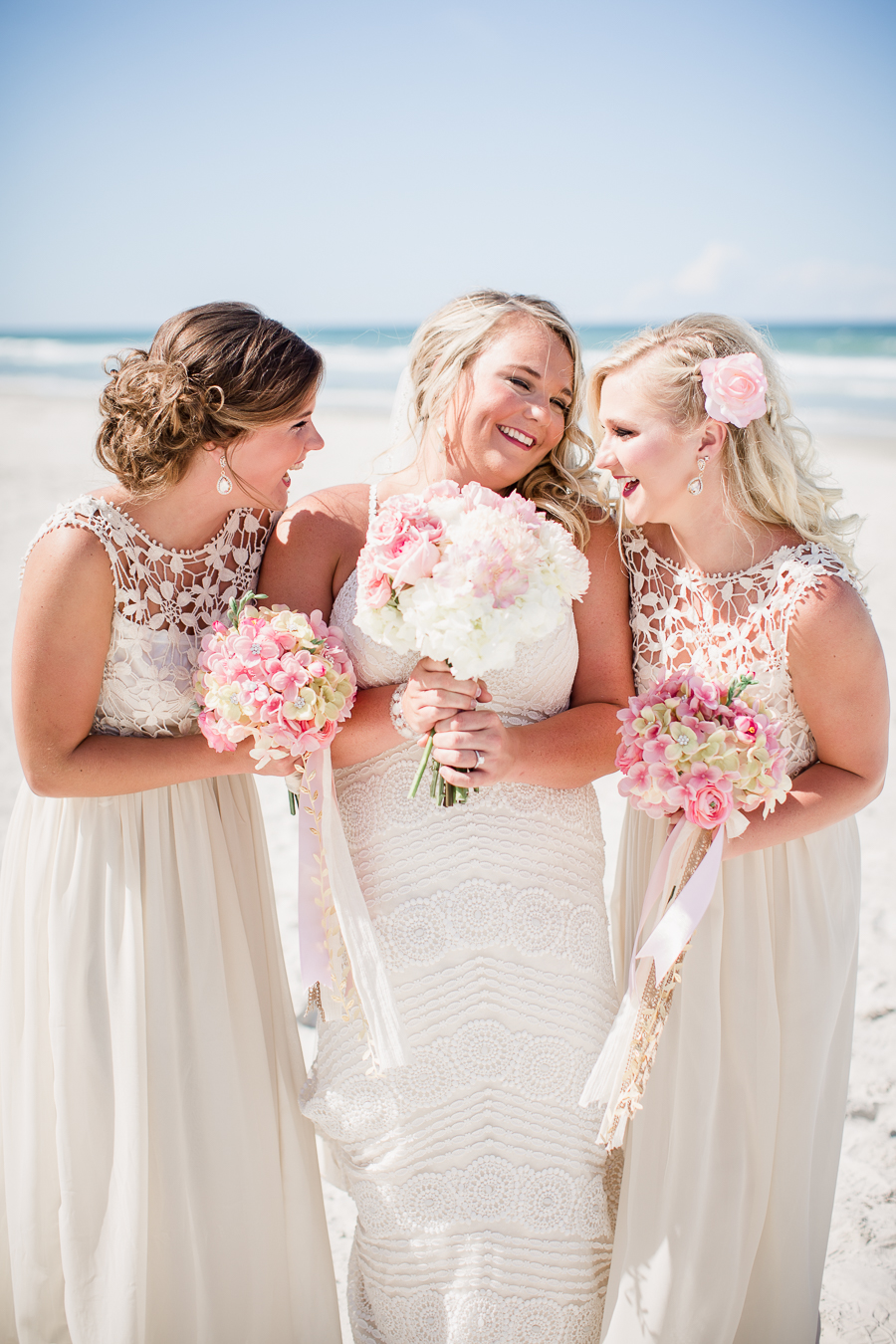 Bride with some of her bridesmaids on beach at this Daytona Beach Wedding by Destination Wedding Photographer, Amanda May Photos.