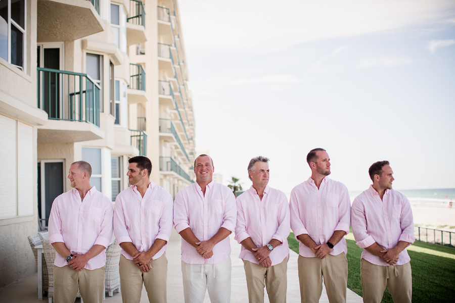 Groom with his groomsmen in front of hotel at this Daytona Beach Wedding by Destination Wedding Photographer, Amanda May Photos.