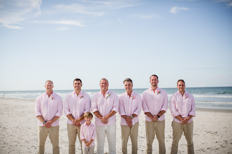 Grooms with groomsmen and ring bear on beach at this Daytona Beach Wedding by Destination Wedding Photographer, Amanda May Photos.