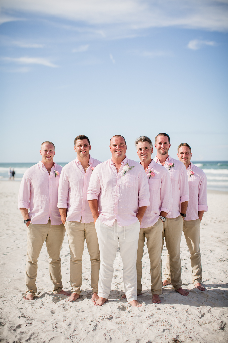 Grooms with groomsmen in V formation on beach at this Daytona Beach Wedding by Destination Wedding Photographer, Amanda May Photos.