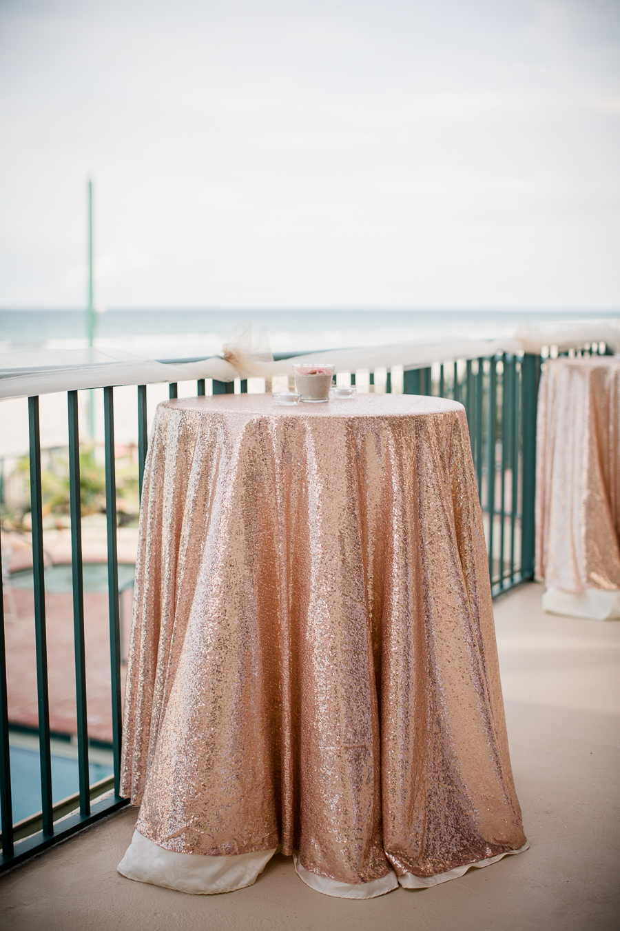 Pink glitter table arrangement with beach background at this Daytona Beach Wedding by Destination Wedding Photographer, Amanda May Photos.
