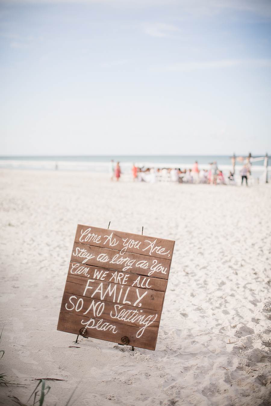 Sitting chart sign on beach at this Daytona Beach Wedding by Destination Wedding Photographer, Amanda May Photos.