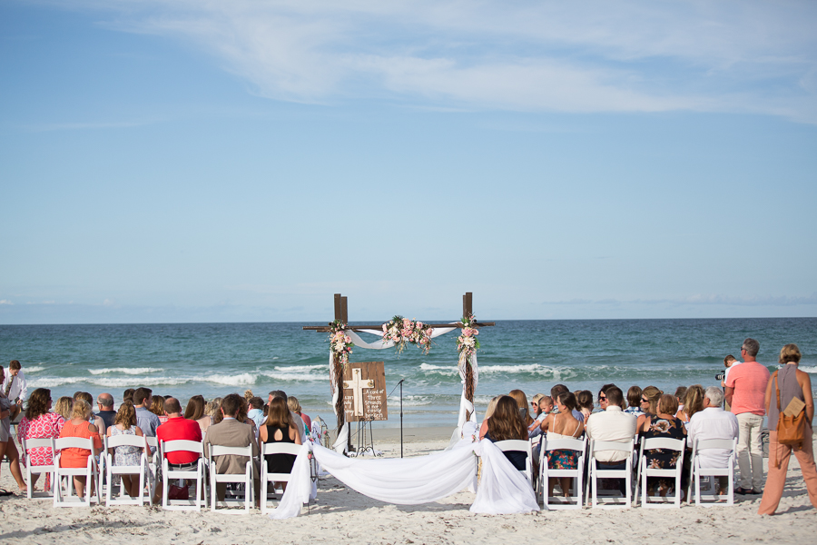 Full view of beach with guests and archway at this Daytona Beach Wedding by Destination Wedding Photographer, Amanda May Photos.