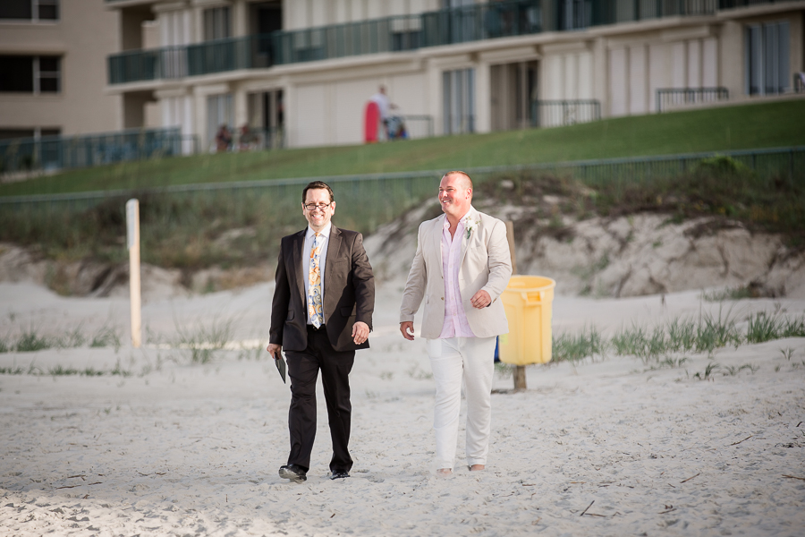 Groom walking down the beach at this Daytona Beach Wedding by Destination Wedding Photographer, Amanda May Photos.