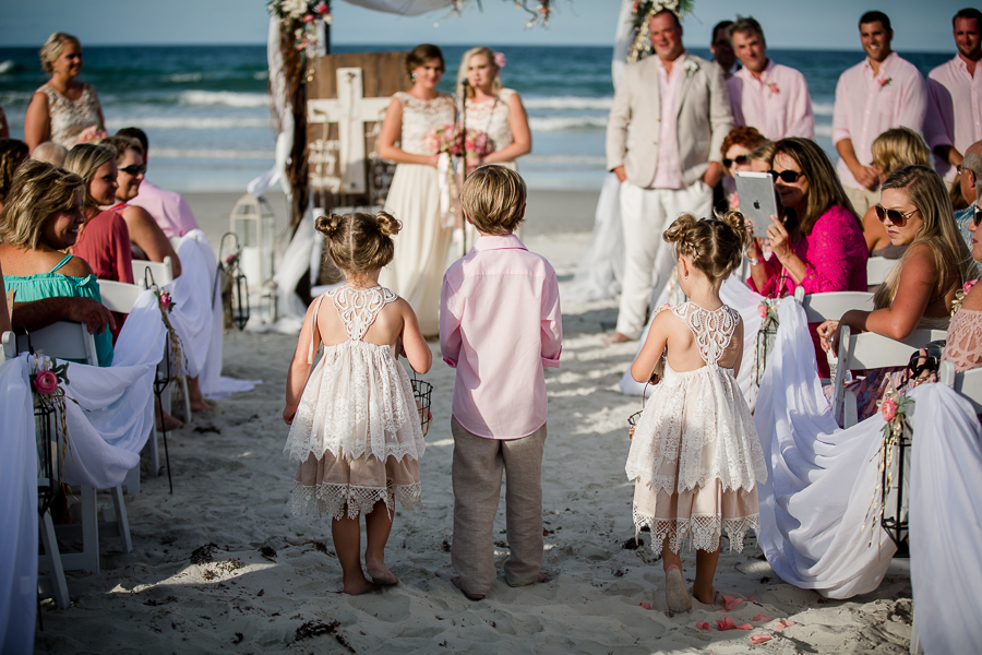 Flower girls and ring bear walking down to the alter at this Daytona Beach Wedding by Destination Wedding Photographer, Amanda May Photos.