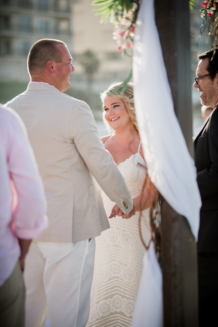 Behind view of bride smiling at groom at this Daytona Beach Wedding by Destination Wedding Photographer, Amanda May Photos.