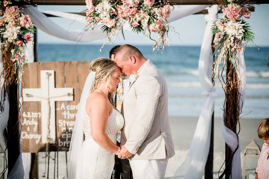 Forehead to forehead at the alter at this Daytona Beach Wedding by Destination Wedding Photographer, Amanda May Photos.