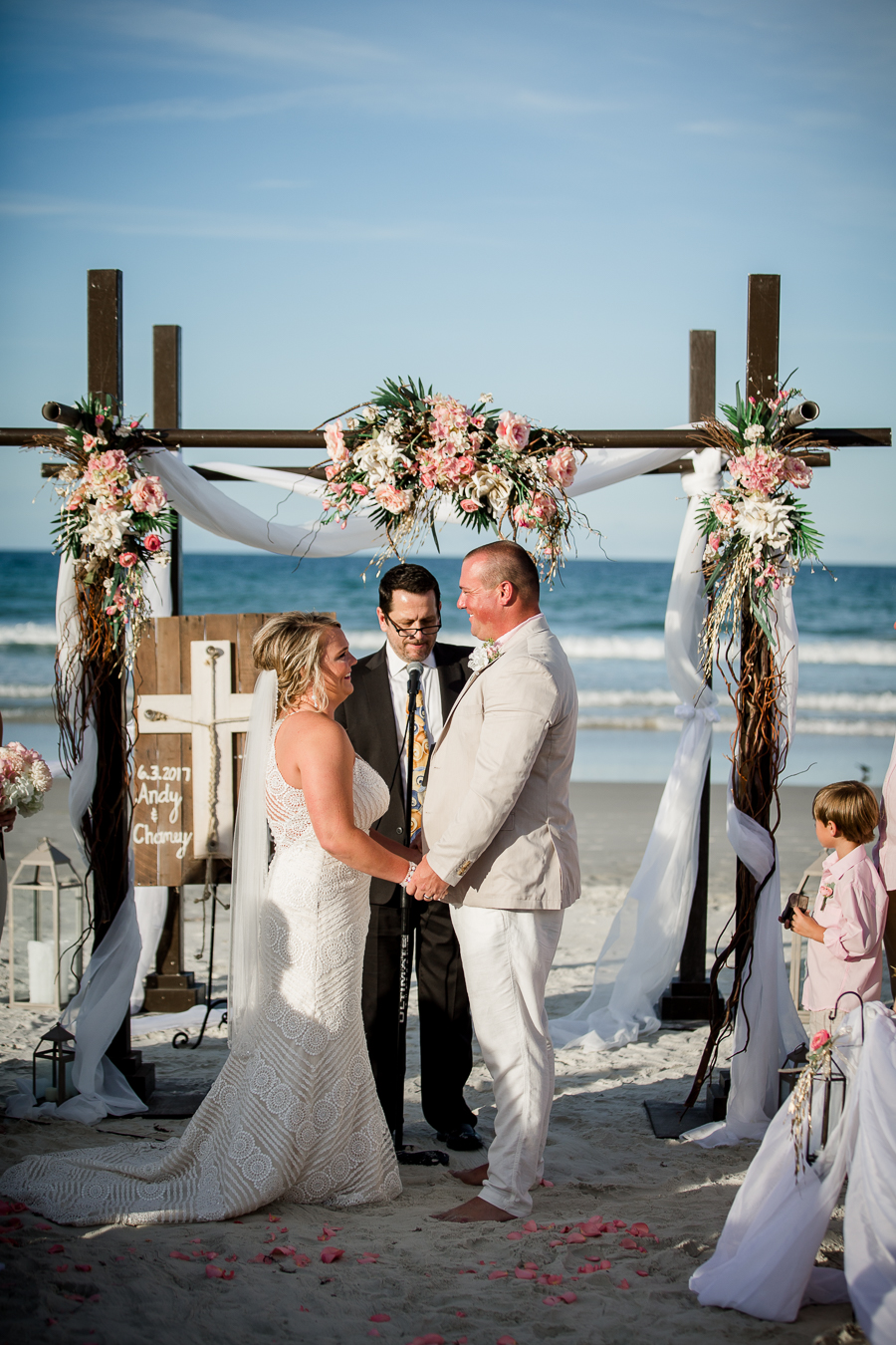 Holding hands at alter at this Daytona Beach Wedding by Destination Wedding Photographer, Amanda May Photos.