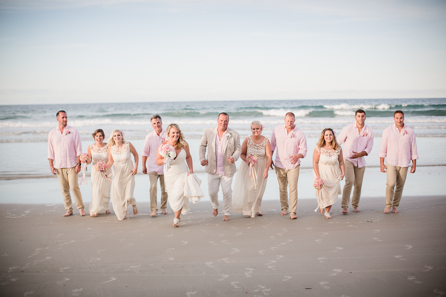 Bridal Party walking on beach at this Daytona Beach Wedding by Destination Wedding Photographer, Amanda May Photos.