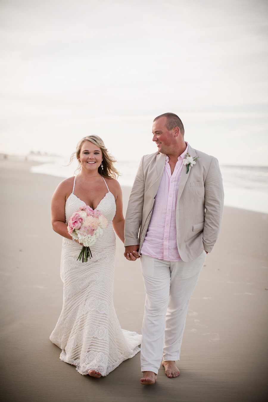 Walking in front of water at this Daytona Beach Wedding by Destination Wedding Photographer, Amanda May Photos.