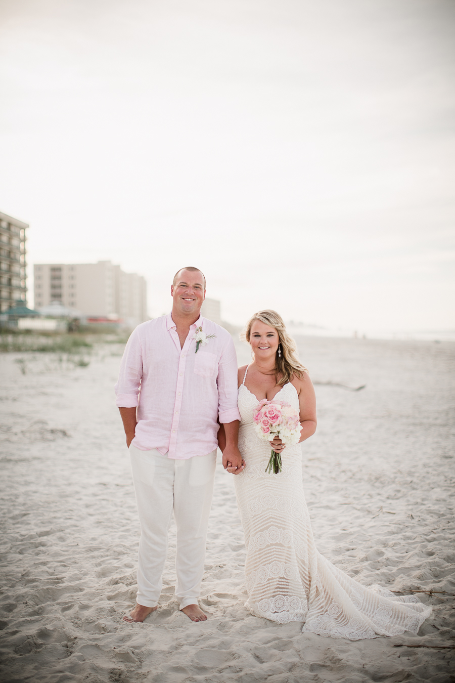 Bride and Groom holding hands on beach at this Daytona Beach Wedding by Destination Wedding Photographer, Amanda May Photos.