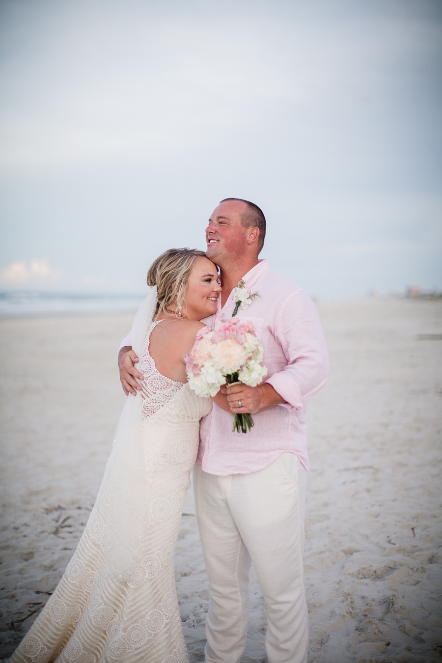 Hugging on the beach at this Daytona Beach Wedding by Destination Wedding Photographer, Amanda May Photos.