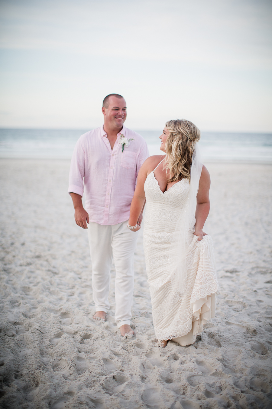 Walking away from water at this Daytona Beach Wedding by Destination Wedding Photographer, Amanda May Photos.