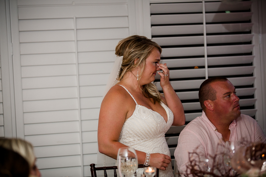 Bride crying at toasts from bridal party at this Daytona Beach Wedding by Destination Wedding Photographer, Amanda May Photos.