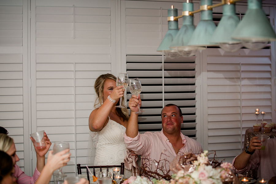 Bride and Groom toasting at this Daytona Beach Wedding by Destination Wedding Photographer, Amanda May Photos.