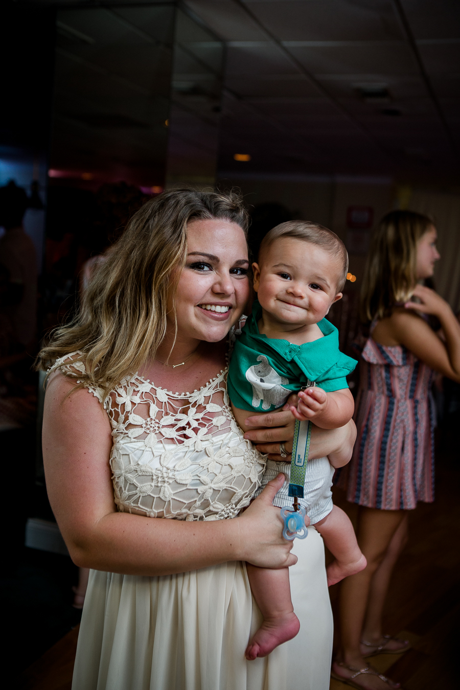 Bridesmaid with little boy at this Daytona Beach Wedding by Destination Wedding Photographer, Amanda May Photos.