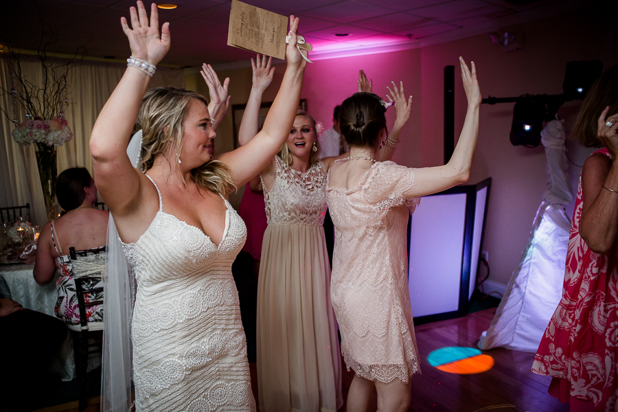 Brie dancing with guests at this Daytona Beach Wedding by Destination Wedding Photographer, Amanda May Photos.