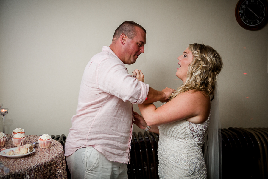 Putting cake on her chest at this Daytona Beach Wedding by Destination Wedding Photographer, Amanda May Photos.