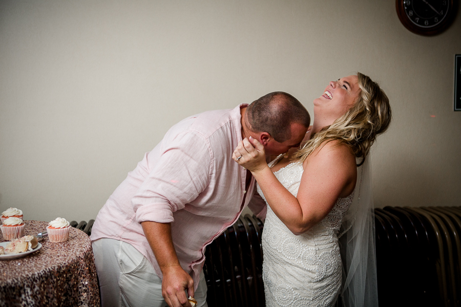 Groom caking cake off Bride at this Daytona Beach Wedding by Destination Wedding Photographer, Amanda May Photos.