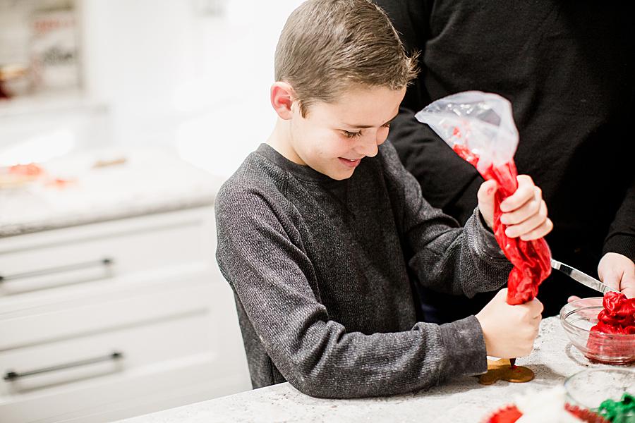 Red icing at this Christmas cookie session by Knoxville Wedding Photographer, Amanda May Photos.