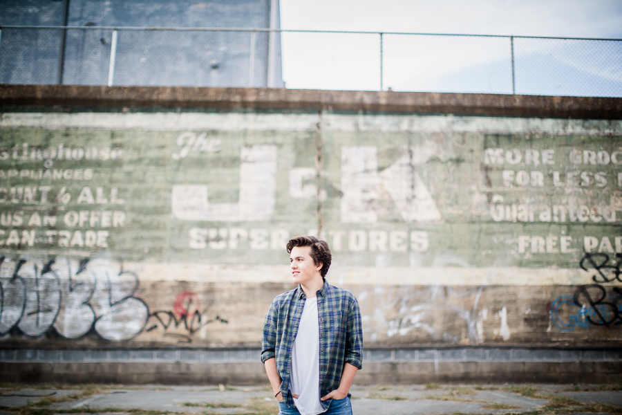 In front of painted wall at this Maryville, TN Senior session by Knoxville Wedding Photographer, Amanda May Photos.